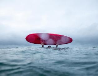 ENSTA Bretagne : étudiant ingénieur du club Yetishape avec sa planche de surf en mer d'Iroise